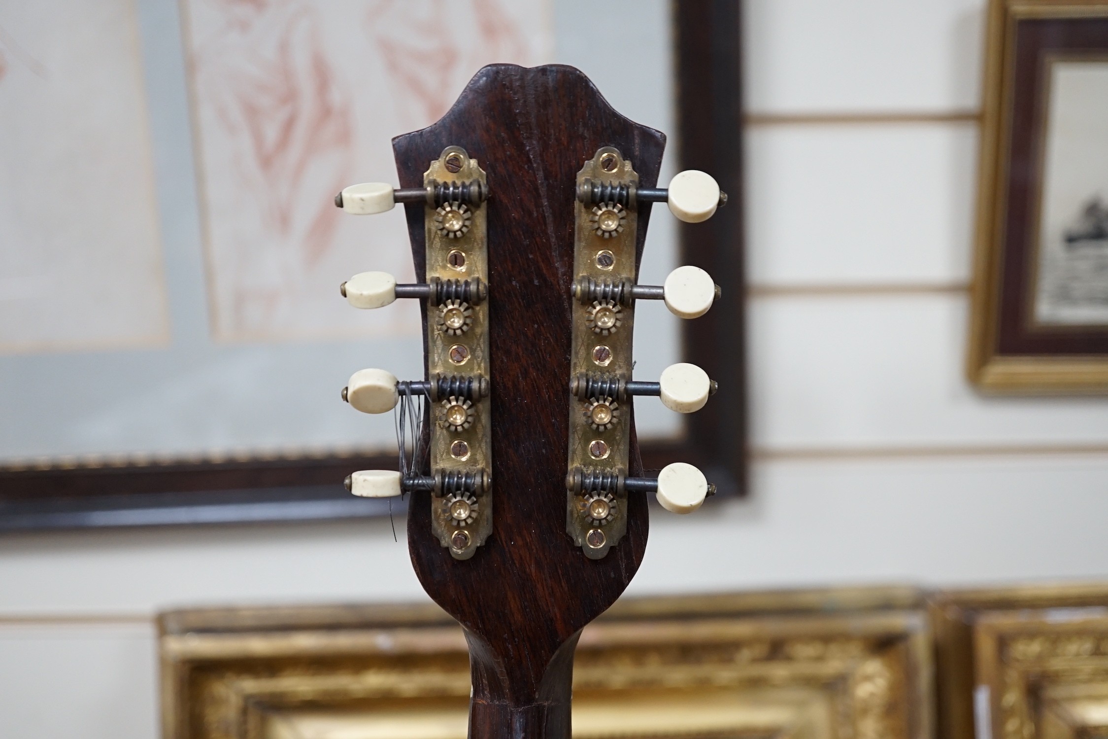A late 19th century German violin together with an Italian mandolin, (both cased)